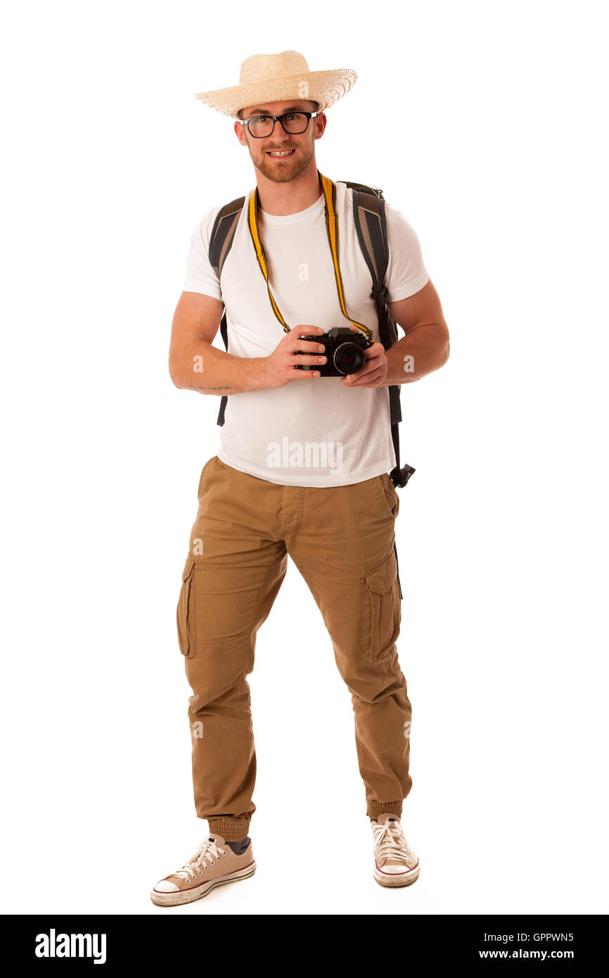 Traveler avec chapeau de paille, chemise blanche, sac à dos de l'appareil photo et d'explorer de nouveaux monde isolé. Banque D'Images