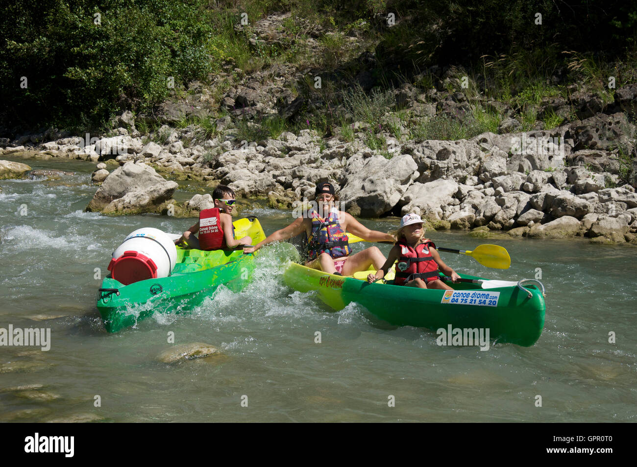 Le tourisme, les loisirs. Une mère et ses deux enfants, Messing sur en canoë, de sortir de la commande vers le bas les eaux turbulentes de la Drôme. La France. Banque D'Images