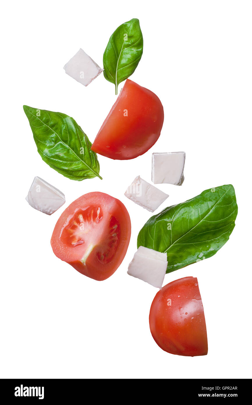 Red chute tomates, mozzarella et basilic isolé Banque D'Images