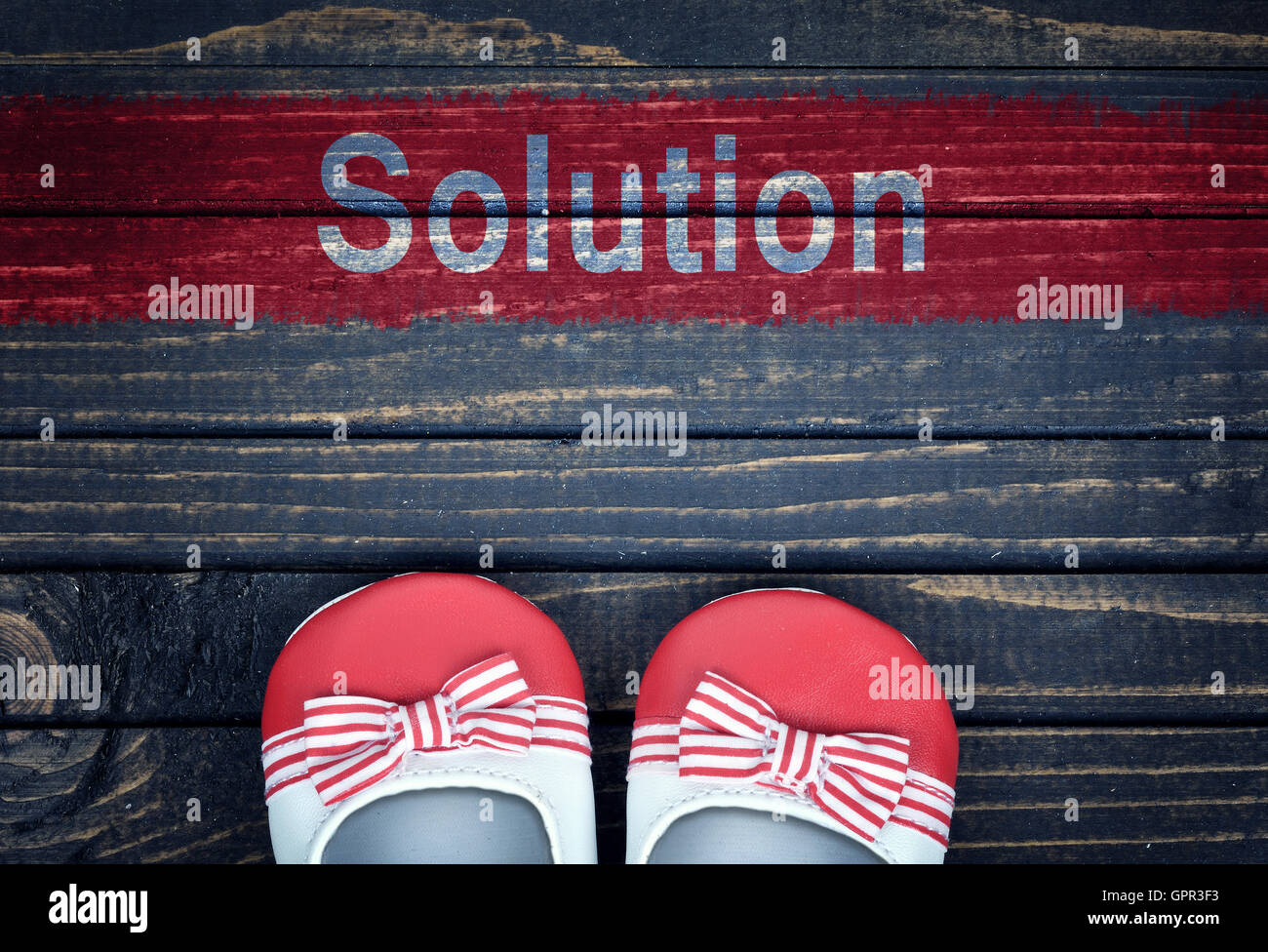 Message Solution et enfants chaussures sur plancher en bois Banque D'Images