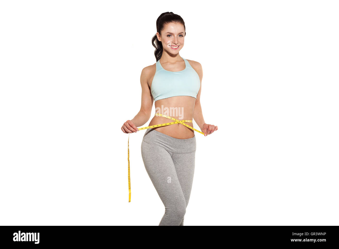 La perte de poids, les sports girl measuring her waist, la formation dans la salle de fitness, gymnastique abdominaux Banque D'Images