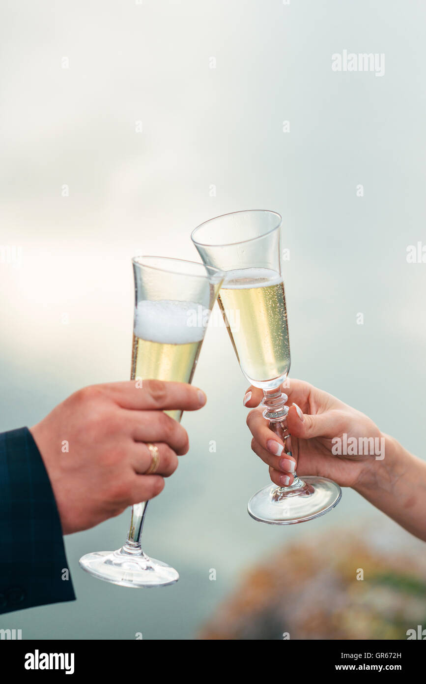 Le couple a célébré leur mariage avec une bouteille de champagne et des verres dans les mains Banque D'Images