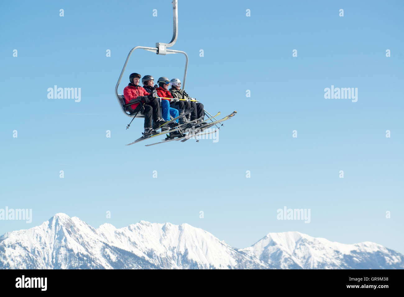 Les skieurs en télésiège sur les montagnes enneigées Banque D'Images