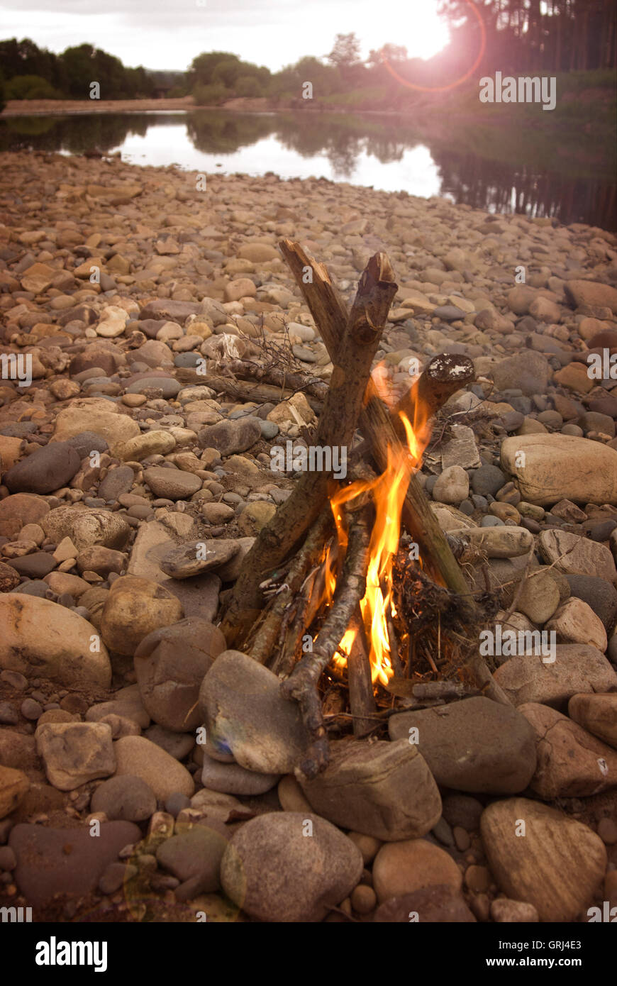 Feu de camp sur une plage de galets de rivière Banque D'Images