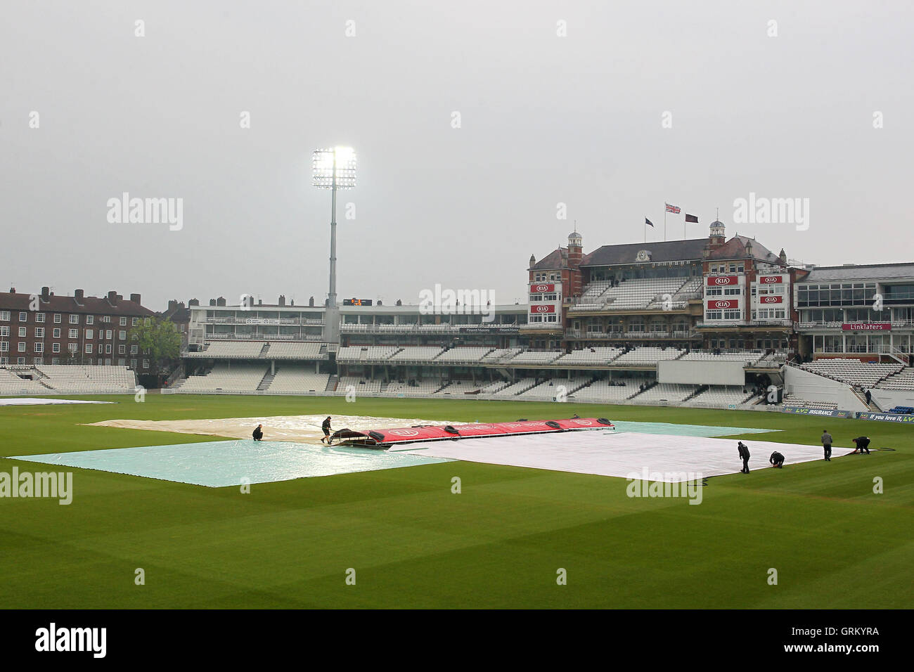 Les couvertures sont sur que la pluie tombe à l'avant de la première journée - Surrey CCC vs Essex CCC - LV County Championship Division Two de cricket au Kennington Oval, Kia, Londres - 20/04/14 Banque D'Images