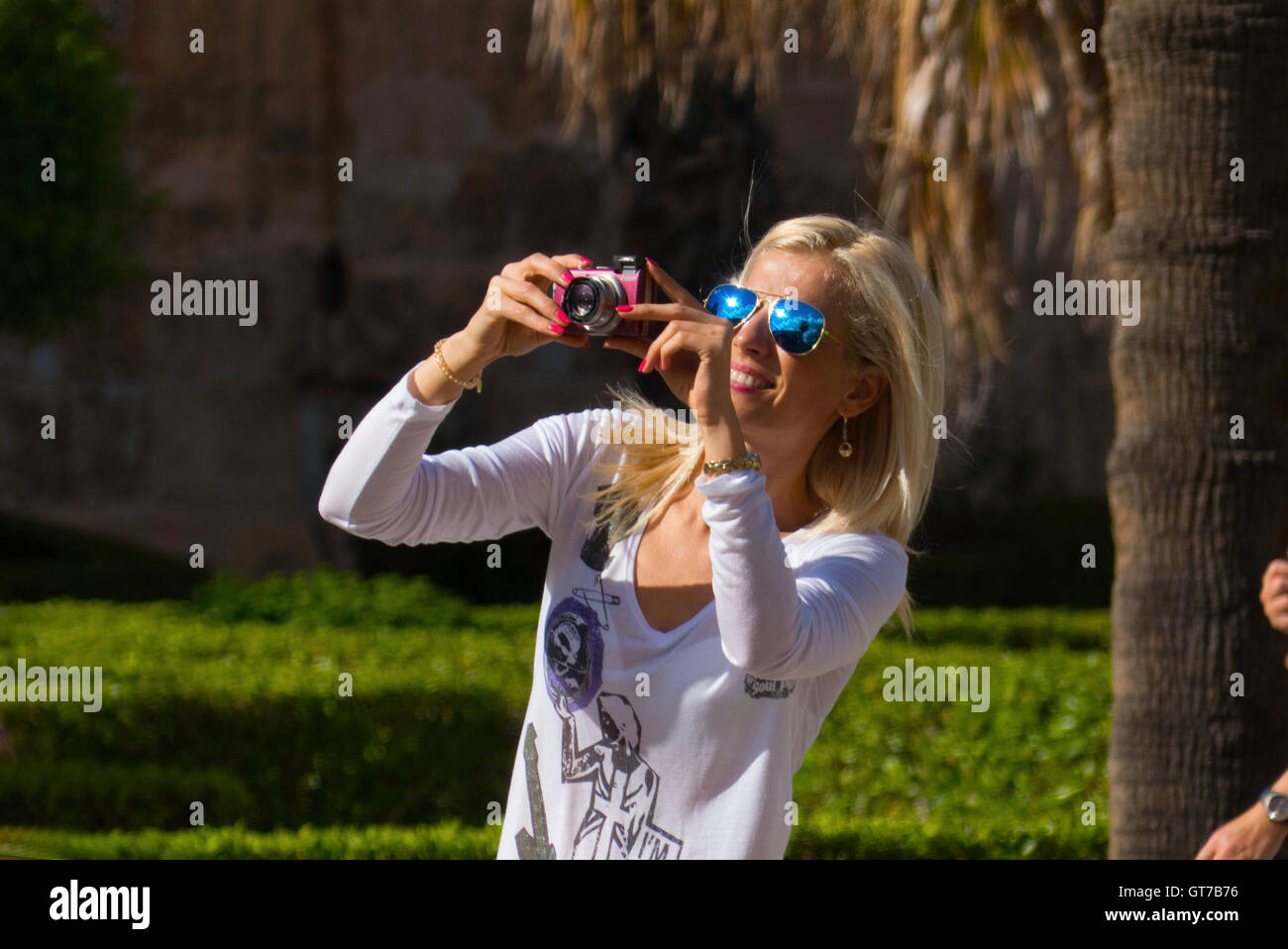 Femme blonde à prendre des photos avec un appareil photo numérique Banque D'Images