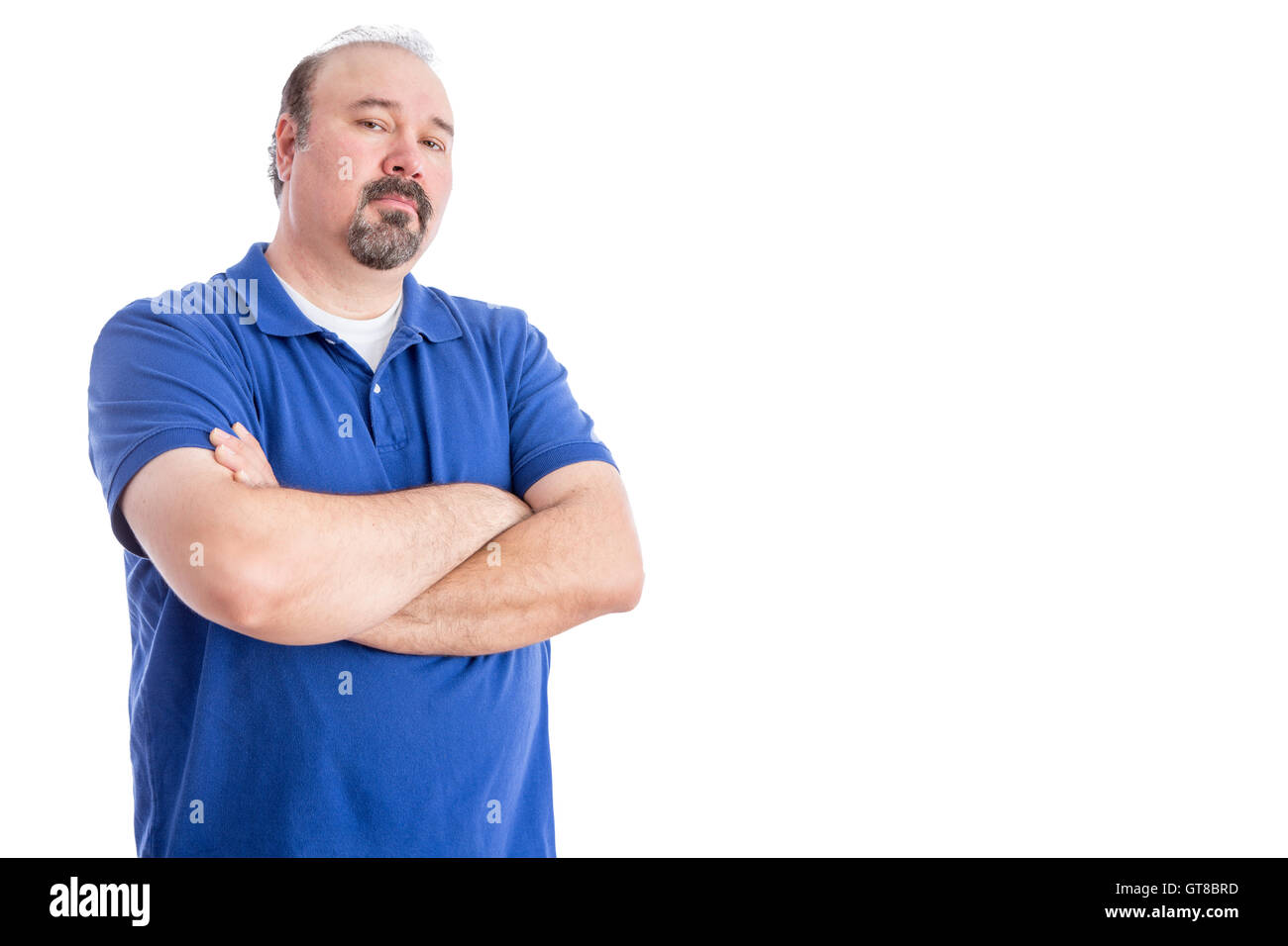 Certain homme adulte en chemise bleue, croisant les bras sur son estomac et regardant la caméra de façon agressive. Isolated on White Banque D'Images