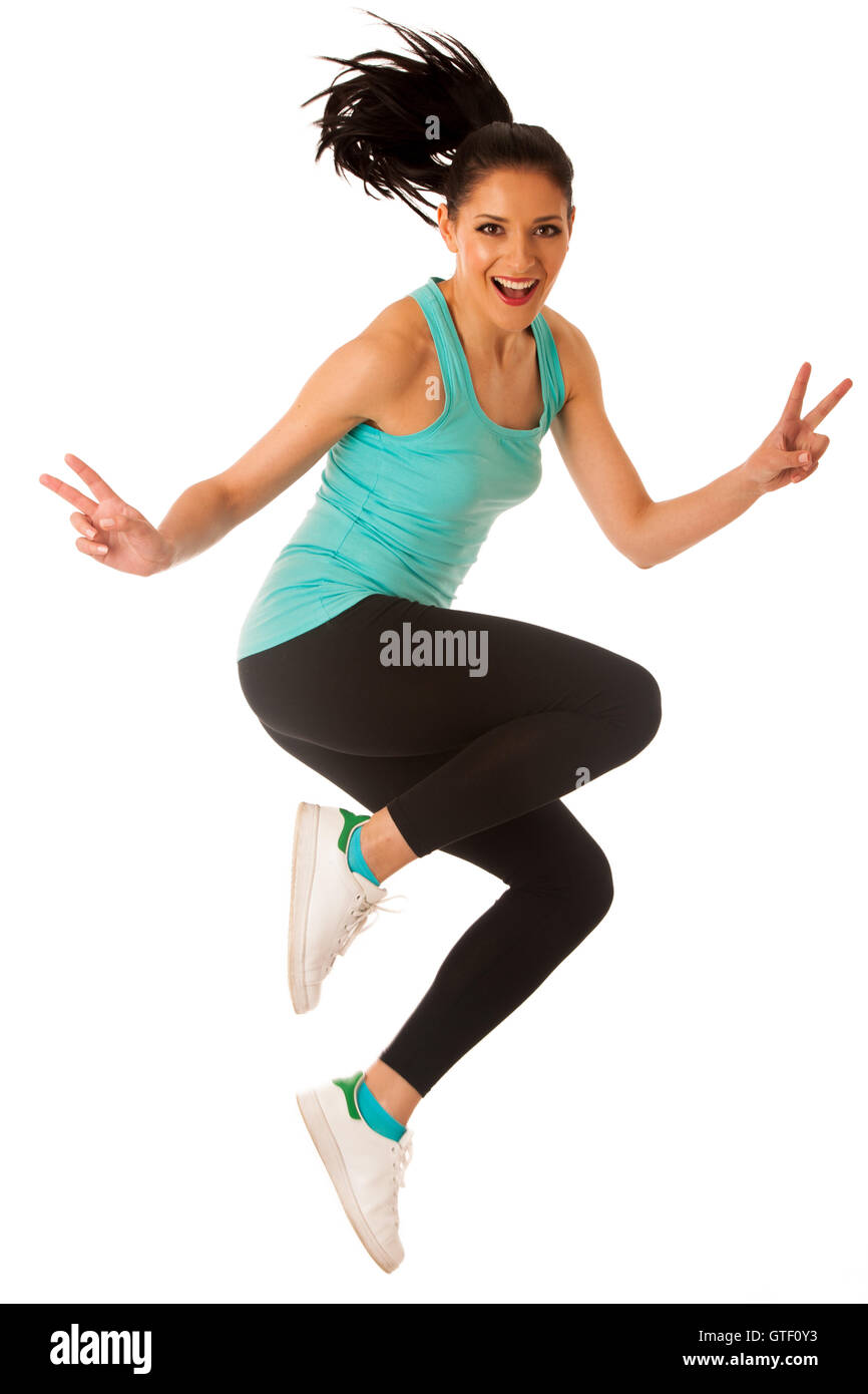 Happy fit et slim femme dansant et sautant isolated over white background Banque D'Images