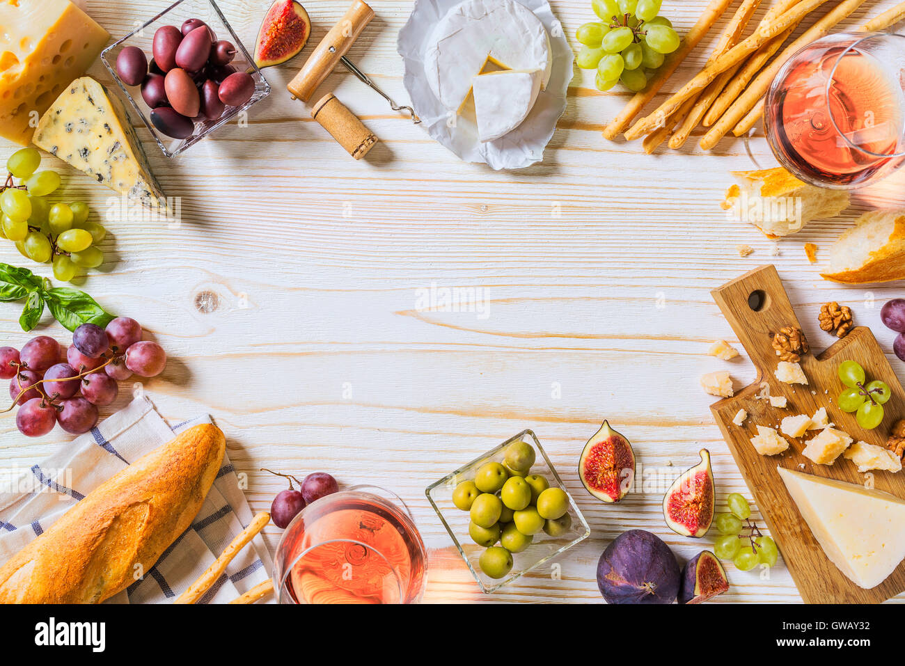 Différents types de fromages, du vin et des collations sur la blanche en bois Banque D'Images