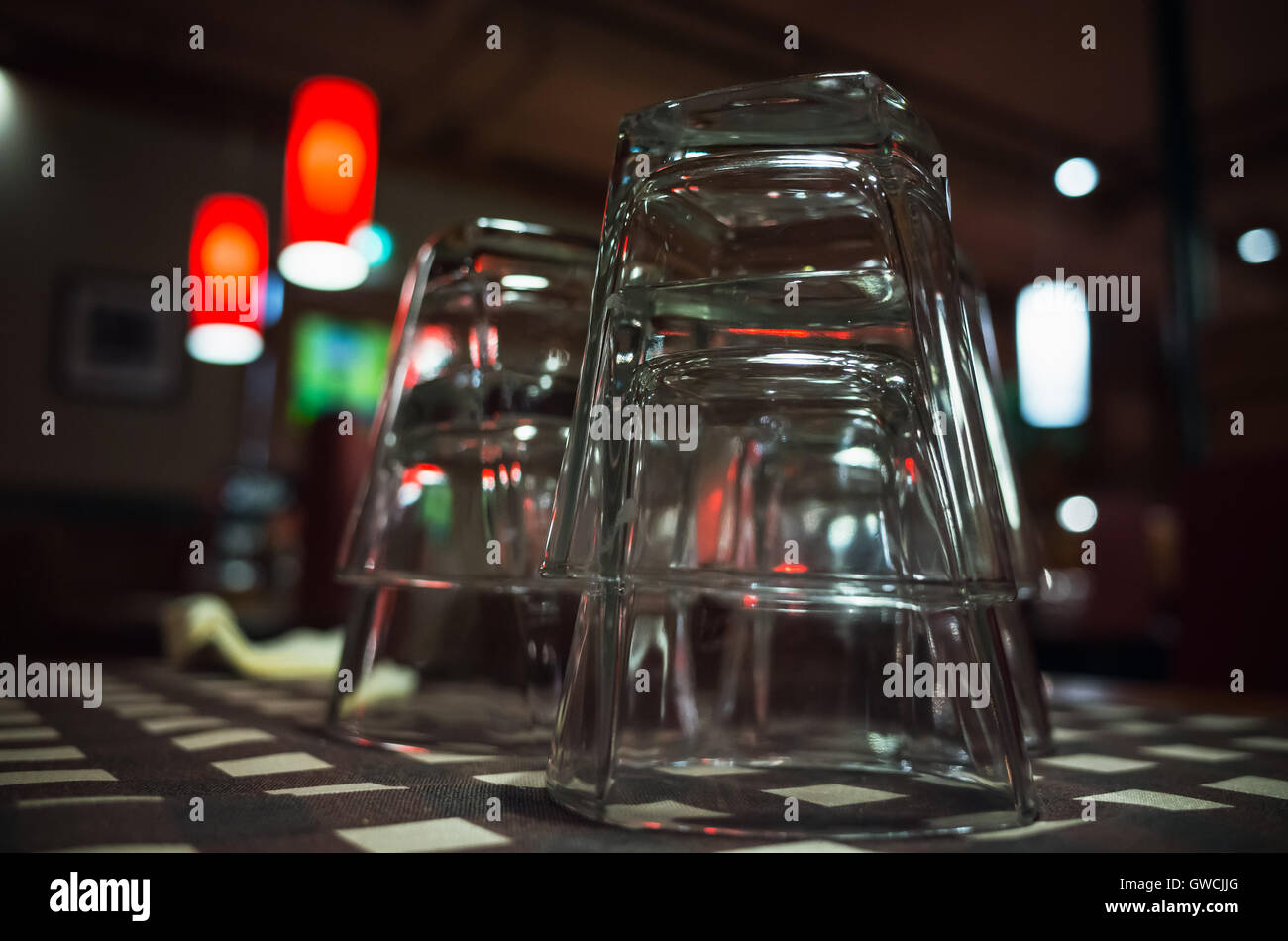 Photo gros plan de verres vides empilées sur table en barre sombre. Selective focus Banque D'Images