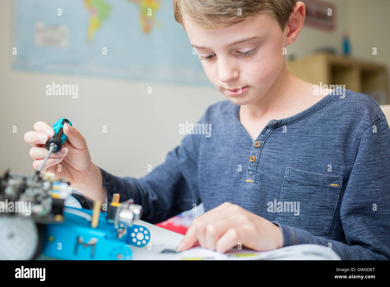 Garçon Kit robotique assemblage dans la chambre Banque D'Images