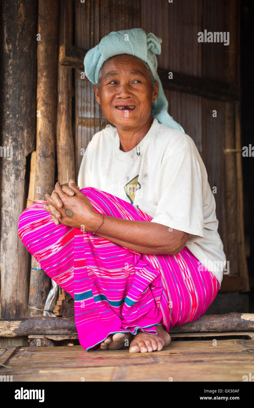 Hill tribu femme du blanc Karen (Kayin) assis dans la robe traditionnelle, à la porte de sa maison, frontière Thaïlande-Myanmar, Asie du Sud-est, Asie Banque D'Images