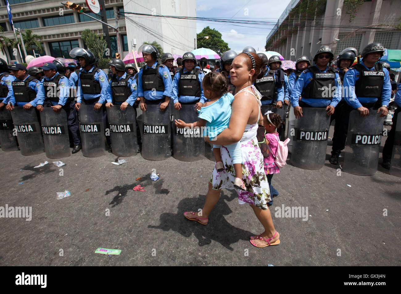 San Pedro Sula, au Honduras. 15 Sep, 2016. Une mère avec ses enfants passe devant un poste de contrôle de la police au cours des célébrations tenues en marge de la commémoration pour les 195 ans de l'indépendance du Honduras, à San Pedro Sula, dans le nord du Honduras, le 15 septembre 2016. Credit : Rafael Ochoa/Xinhua/Alamy Live News Banque D'Images