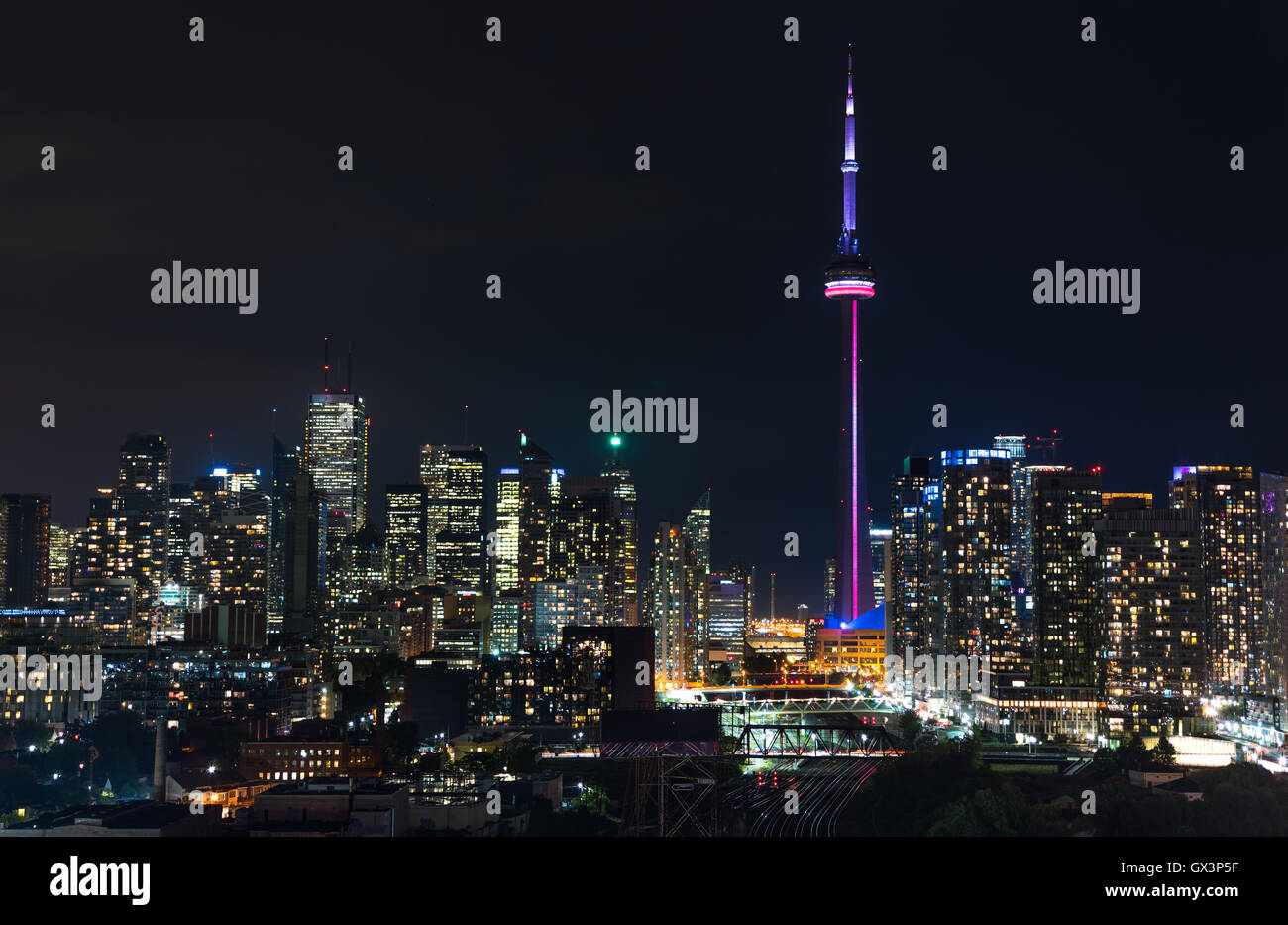 Paysage éclairé urbaine de Toronto. Des toits de bâtiments et tours de bureaux sur un chaud, Août pluvieux et humide de la nuit. Banque D'Images