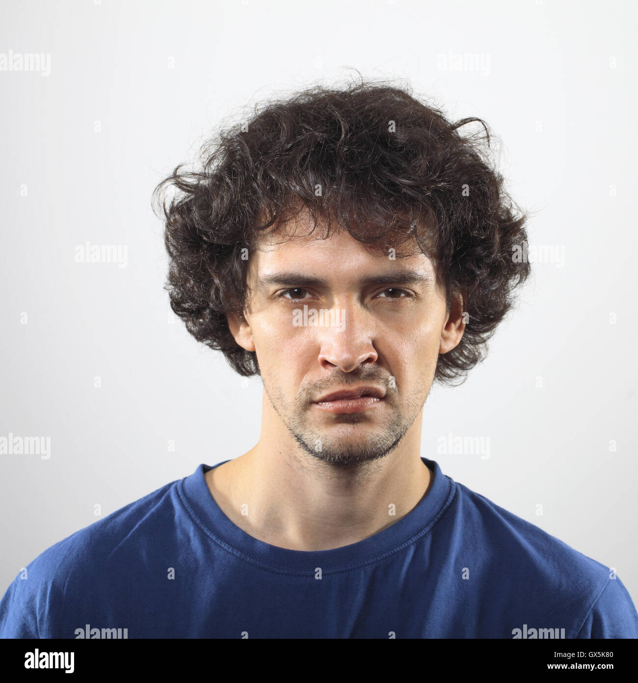 Angry Young Man in blue shirt portrait. Banque D'Images