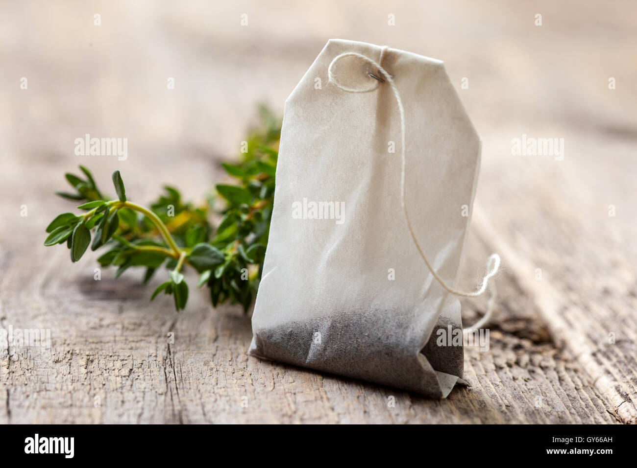 Sachet à thé et thym frais sur un vieux fond de bois Banque D'Images