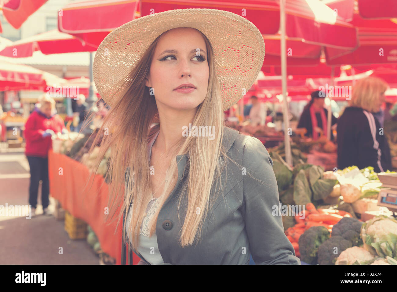 Portrait of attractive blonde woman with straw hat le marché. Poste a traité avec filtre vintage. Banque D'Images