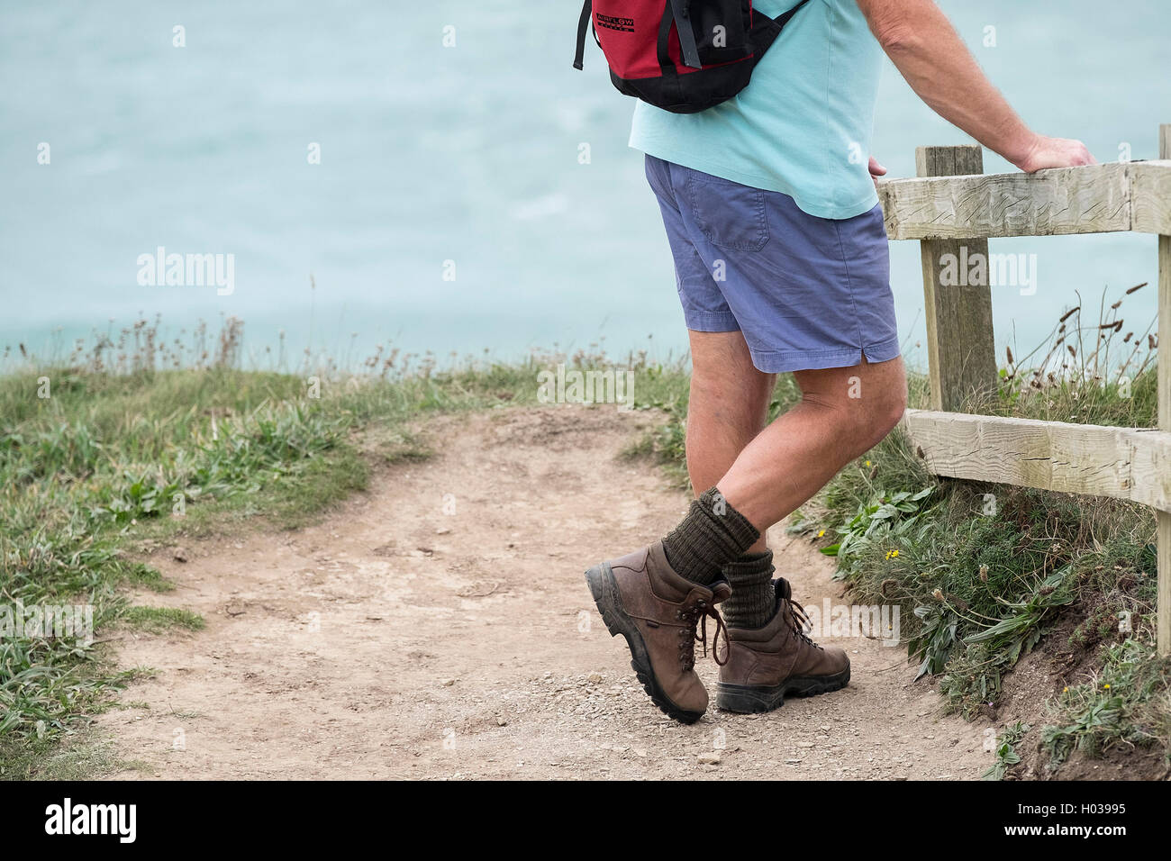 Un walker prend un repos sur le chemin côtier du sud-ouest dans la région de Cornwall. Banque D'Images