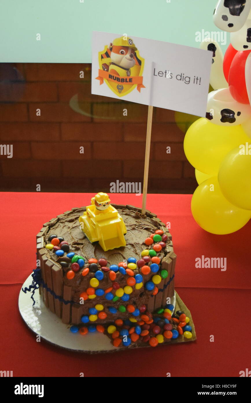 Patrouille patte d'anniversaire ballon torsion et gâteau au chocolat Banque D'Images