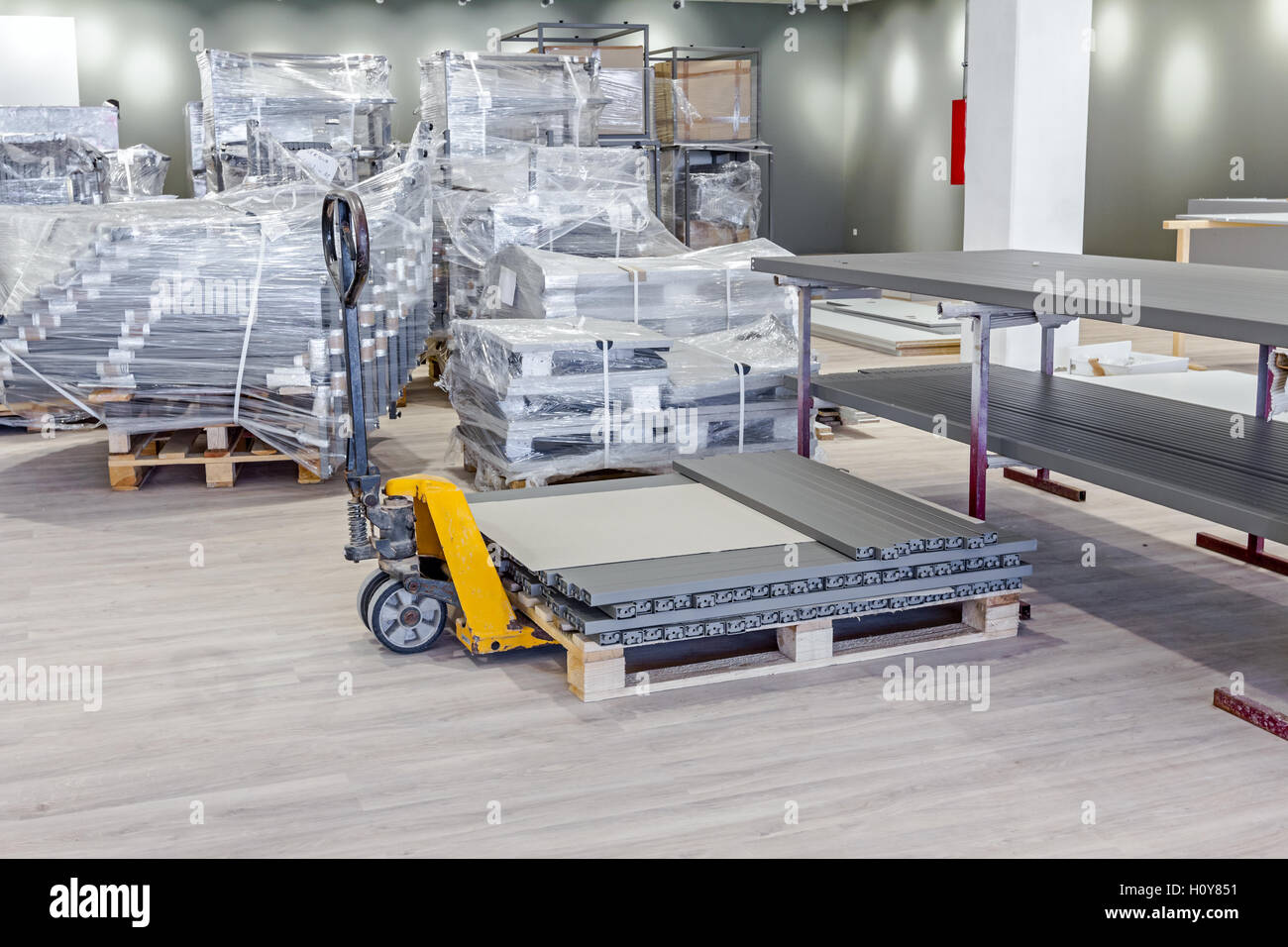 Caisses en plastique jaune, transpalette, gerbeur piétonne pour le transport des palettes d'ameublement équipement. Banque D'Images