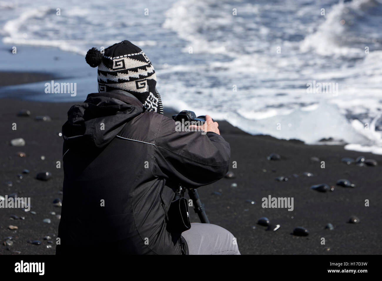Photographe à prendre des photos de glace échoués sur la plage de sable noir à l'islande jokulsarlon Banque D'Images