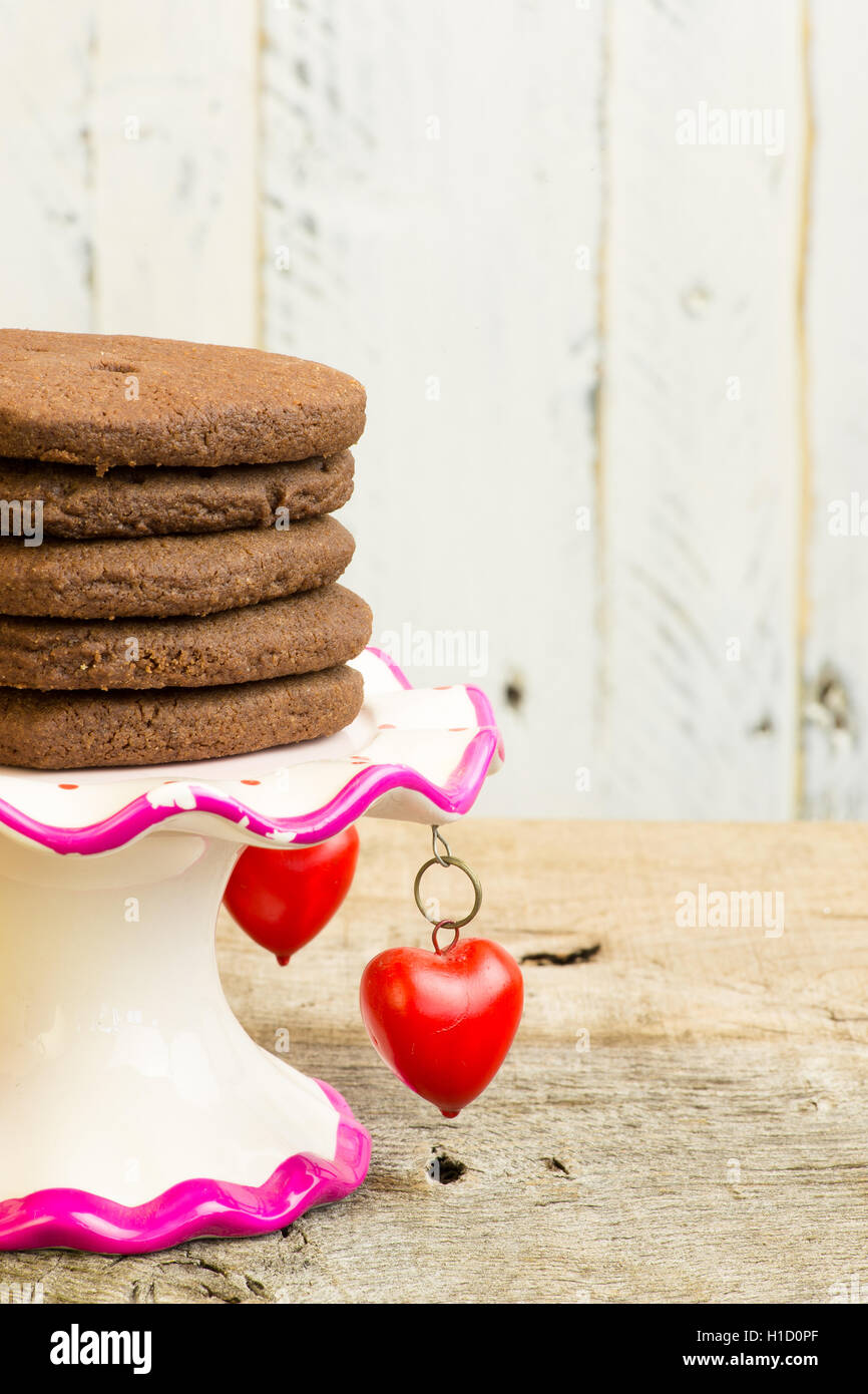 Chocolat chaud mexicain heart shaped shortbread cookies avec le poivre de cayenne et la cannelle sur un stand avec des pendentifs coeur rouge Banque D'Images