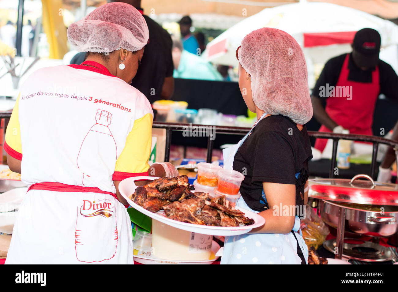 Abidjan, Côte d'Ivoire, le 11 septembre 2016 : partie de barbecue à  Abidjan. Jeune femme bac rempli de la main du poisson grillé Photo Stock -  Alamy