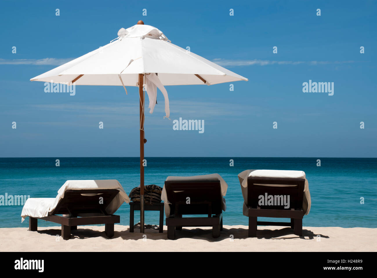 3 chaises et un parasol sur la plage de Phuket, Thaïlande. L'image n'est pas aiguisé pour l'avenir de l'édition. Banque D'Images