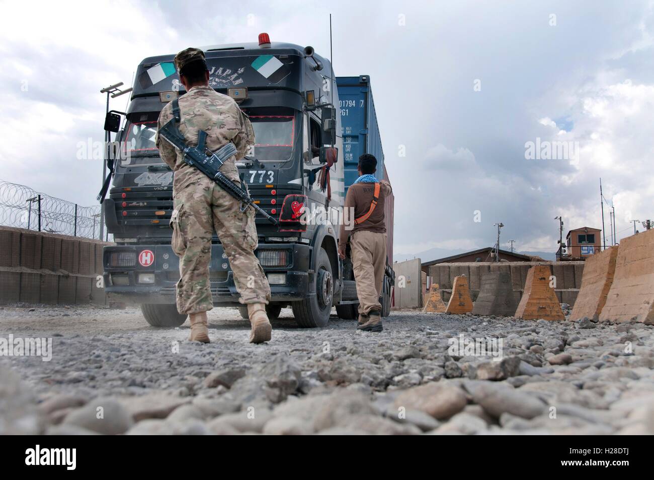 Un soldat de l'armée américaine autorise les conducteurs de camion de passer par l'aéroport de Bagram, le 8 septembre 2014 dans la province de Parwan, Afghanistan. Banque D'Images