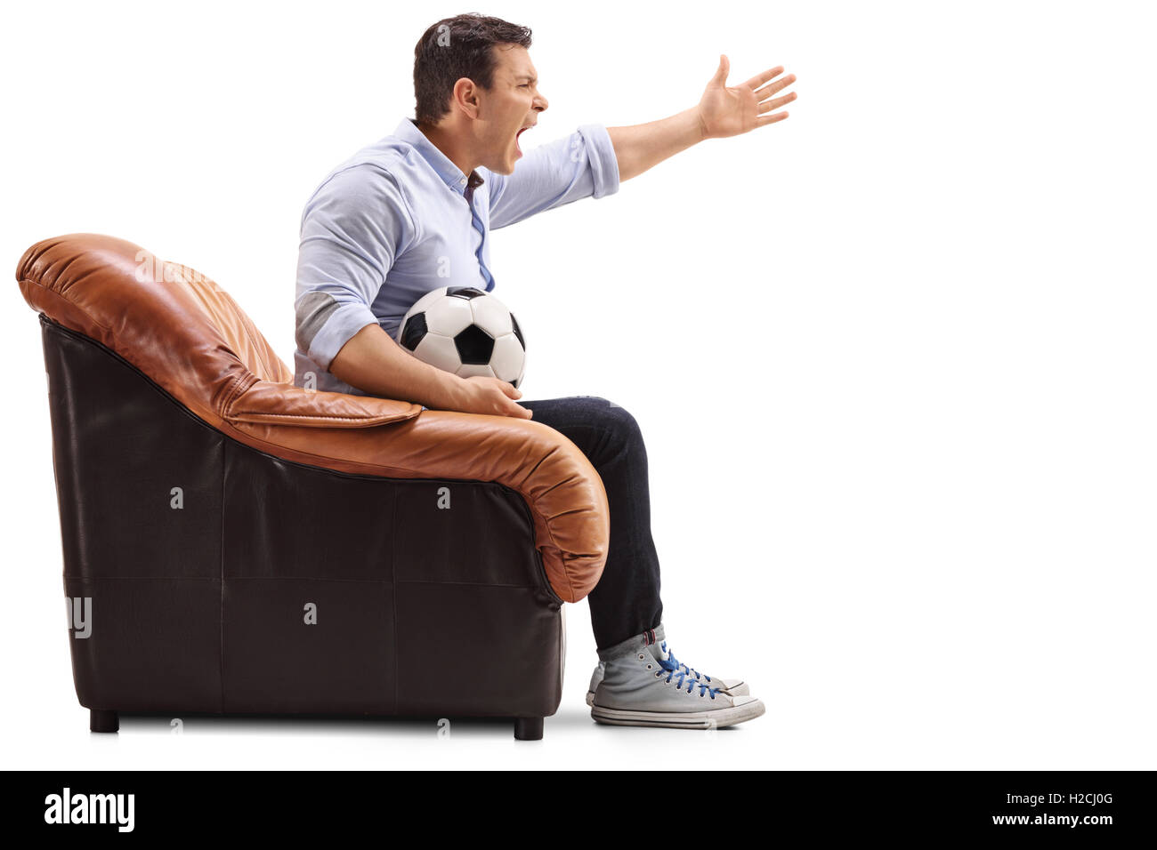 Agacé homme assis sur un fauteuil à regarder le football et hurler isolé sur fond blanc Banque D'Images