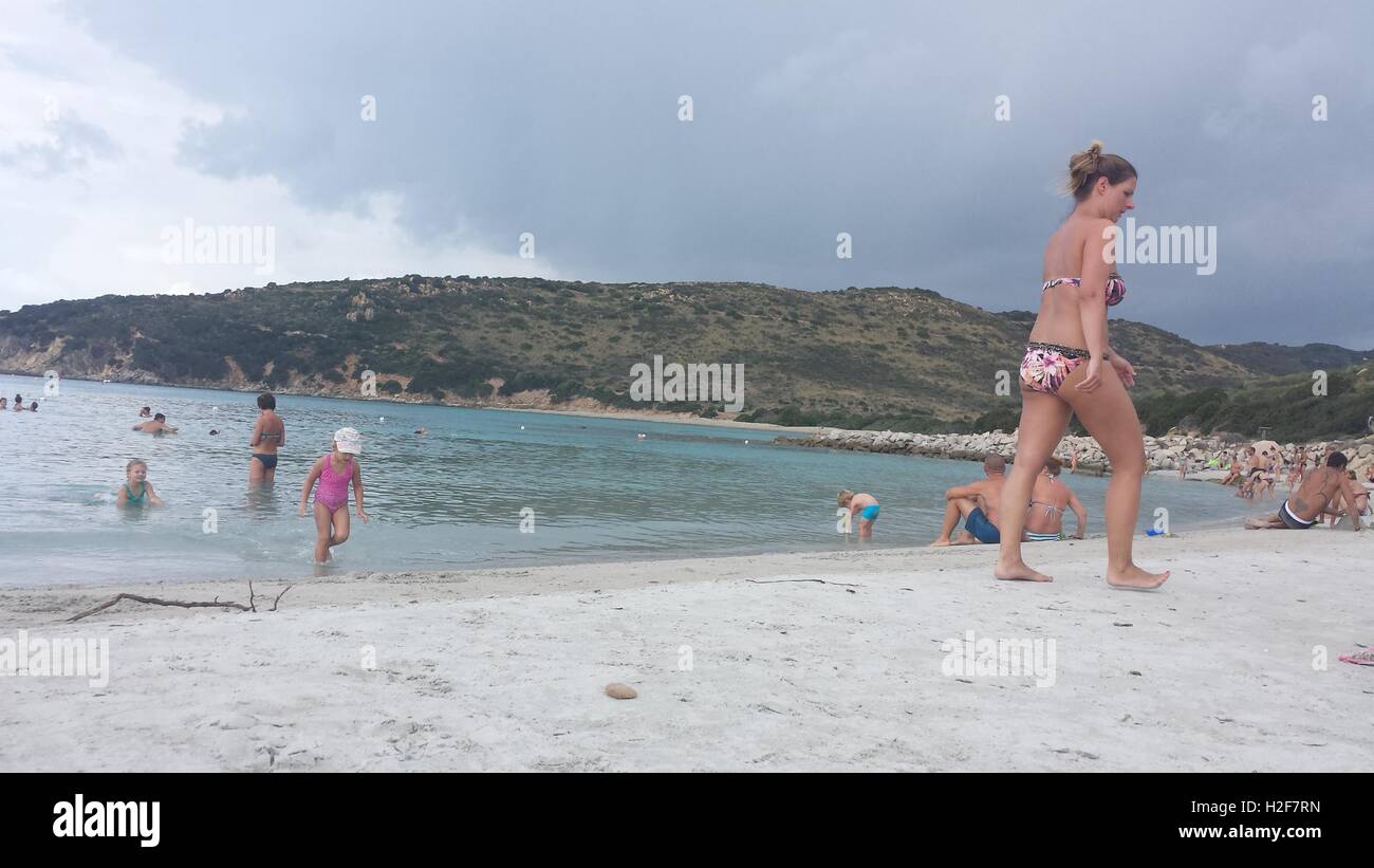 Plage de Punta Molentis, Perugia - 26 Septmber 2016 : uninidentify les gens sur la plage alors qu'un nuage noir est entrée dans le ciel Banque D'Images