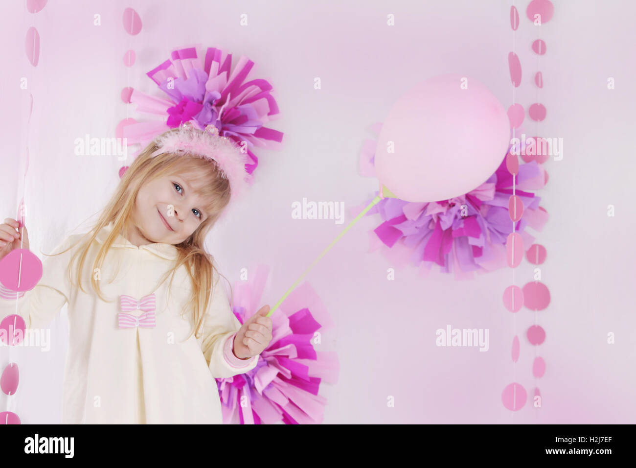 Petite fille à l'anniversaire avec décoration rose balloon Banque D'Images