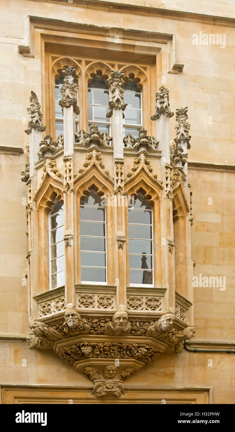 Fenêtre en baie entourée de très décoratif de style gothique de la sculpture sur pierre à l'entrée du quartier historique Pembroke College à Oxford en Angleterre Banque D'Images