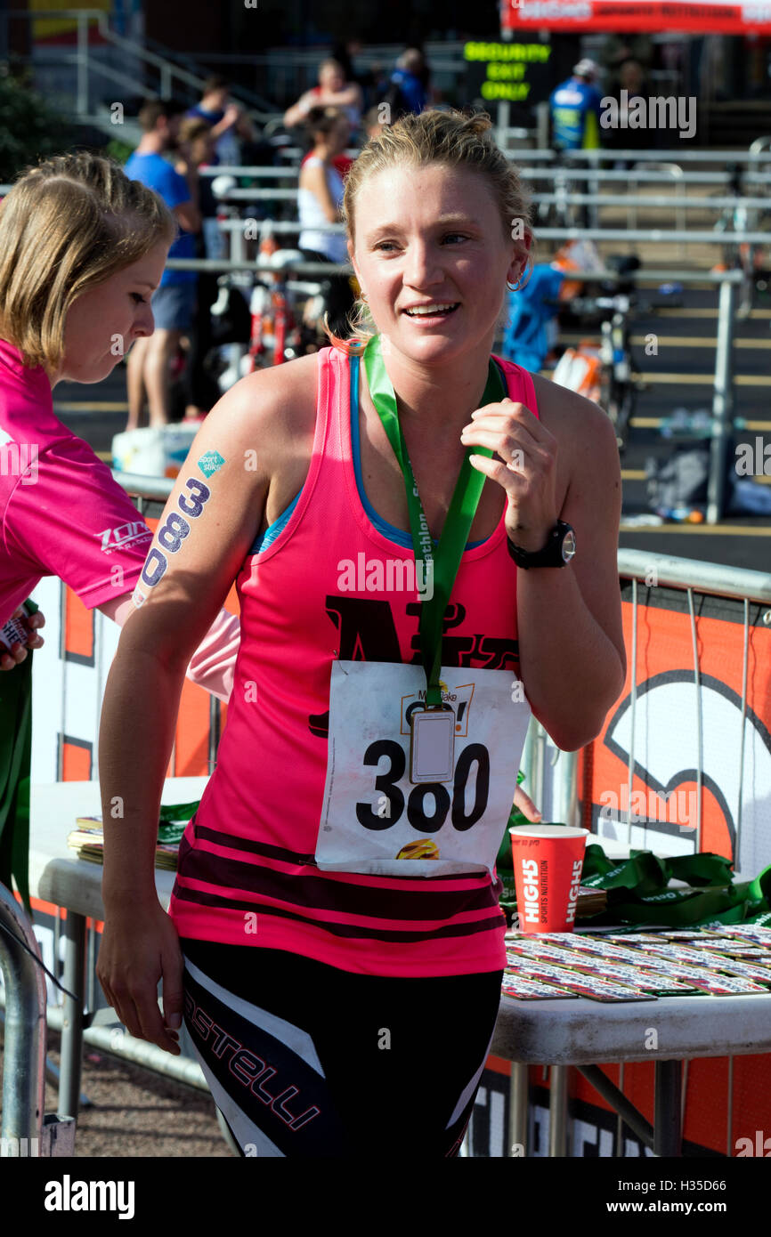 Un concurrent de sexe féminin à l'arrivée de la Warwickshire Triathlon, Stratford-upon-Avon, Royaume-Uni Banque D'Images