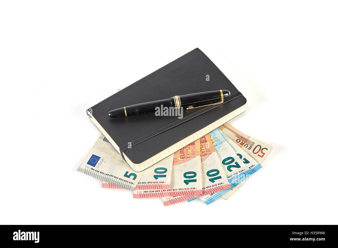 Gagner de l'argent avec l'écriture symbolisé avec stylo et portable sur l'argent euro banknotes Banque D'Images