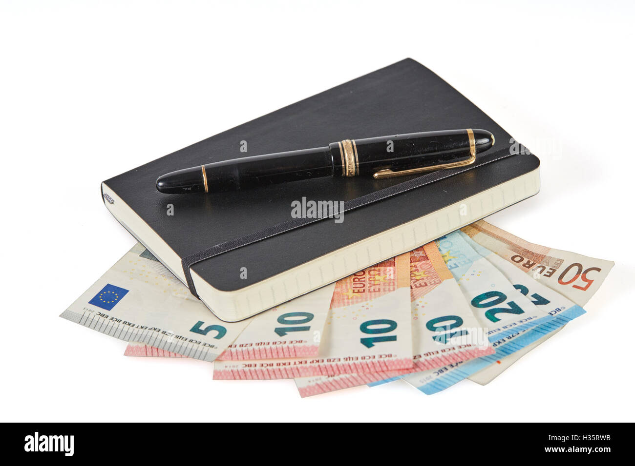 Gagner de l'argent avec l'écriture symbolisé avec stylo et portable sur l'argent euro banknotes Banque D'Images