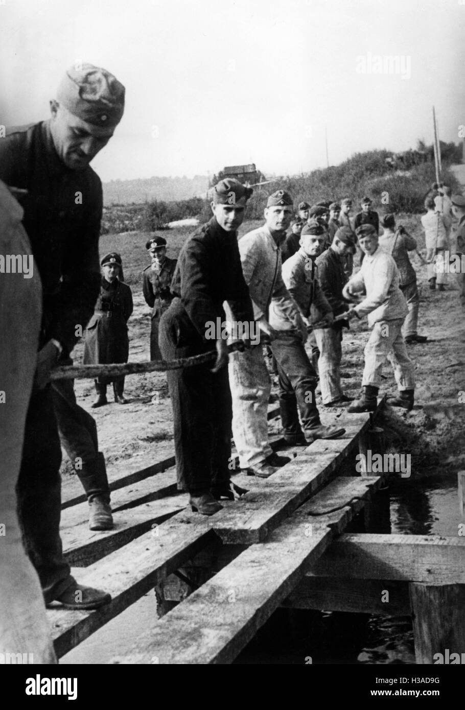 Les soldats allemands portant les câbles téléphoniques sur le Dniepr 1941 Banque D'Images