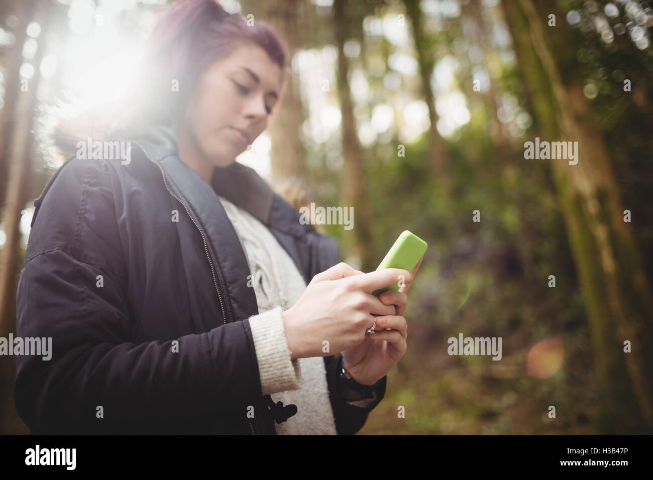 Vue latérale du woman using smartphone Banque D'Images