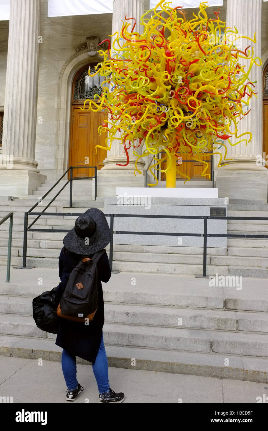 Une femme regarde le soleil par Dale Chihuly à l'extérieur du Musée des beaux-arts de Montréal. Banque D'Images