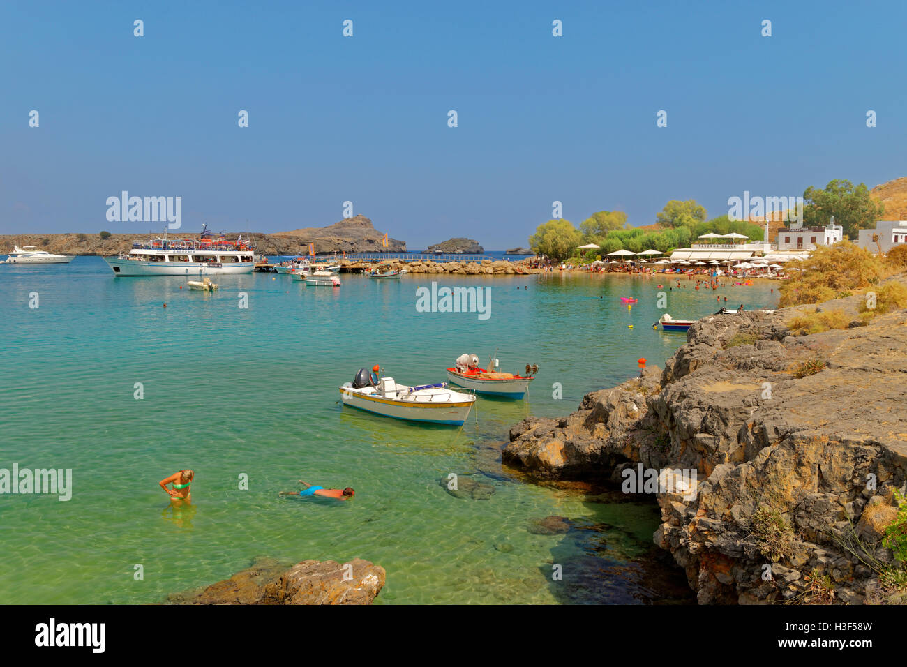 Plage de Lindos sur la côte sud-est de l'île de Rhodes, l'île du Dodécanèse, Grèce Groupe. Banque D'Images