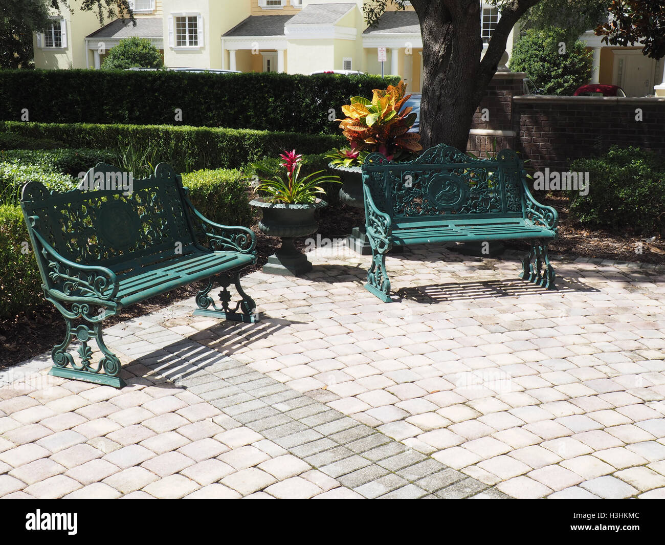 Deux bancs en fer forgé par un patio. Banque D'Images