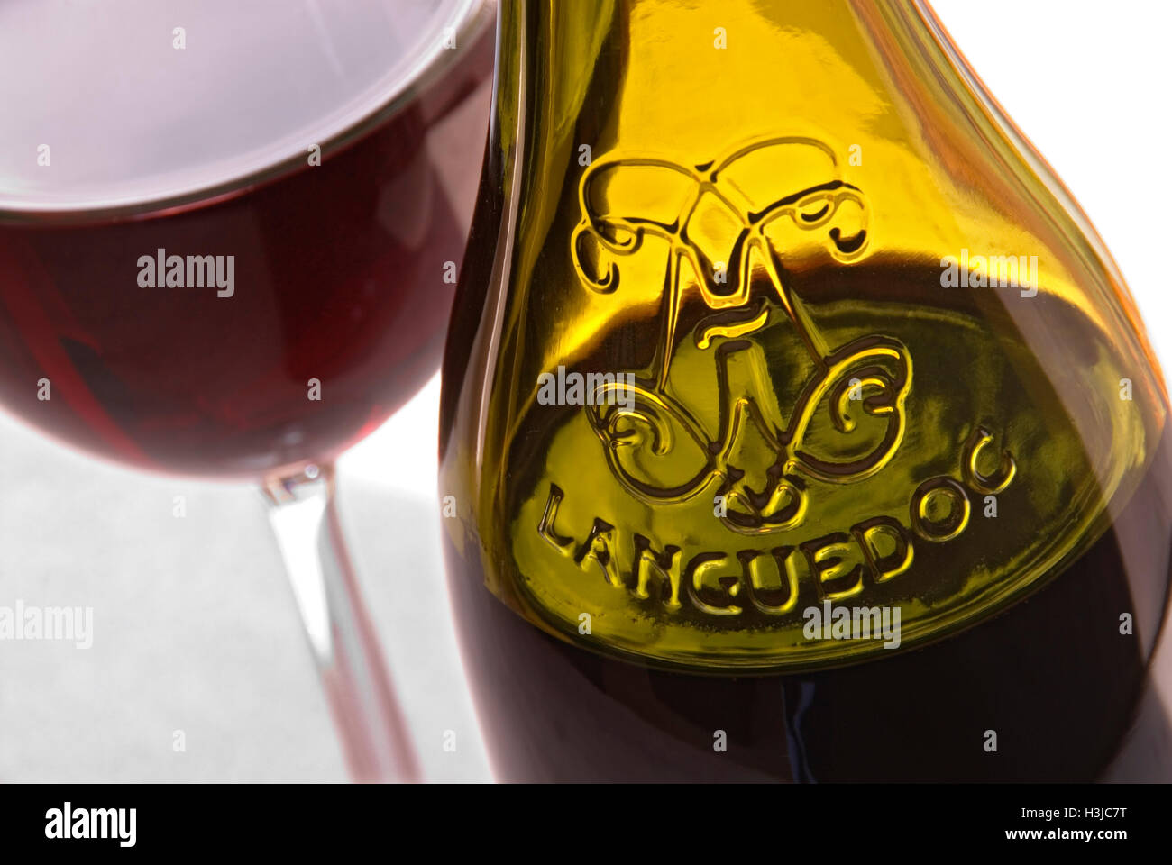 Verre à vin rouge Languedoc et bouteille en relief sur la terrasse ensoleillée Table Sud de la France Banque D'Images