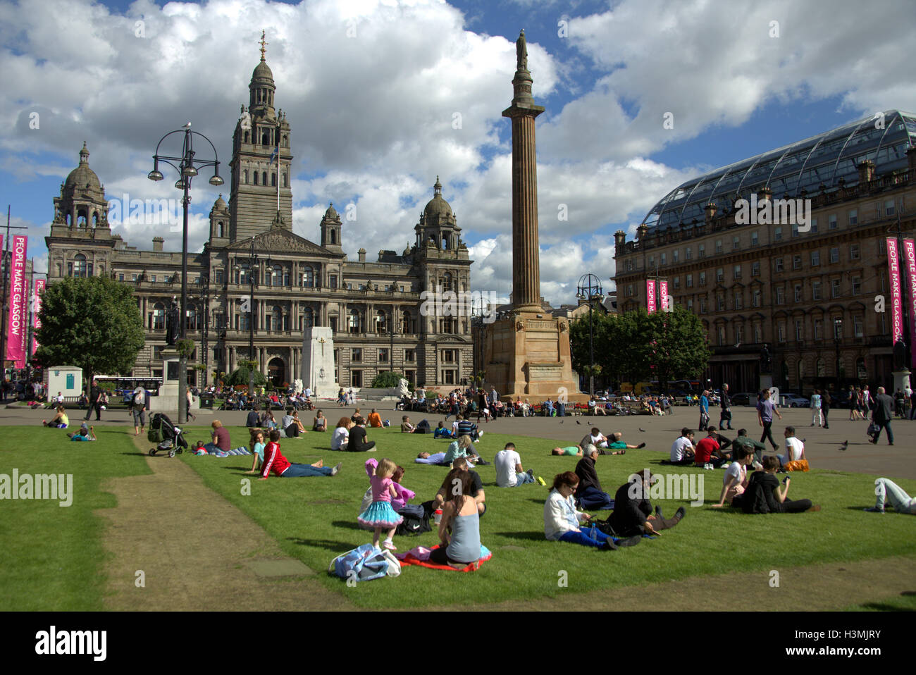 George Square et la ville chambres avec le cénotaphe situé dans le centre-ville de Glasgow center les habitants et les touristes se détendre et profiter du soleil Banque D'Images