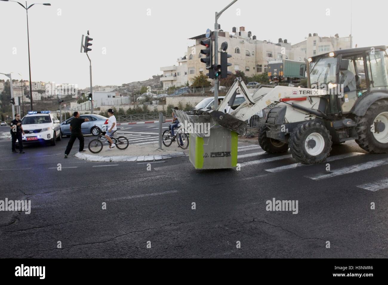 (161011) -- JÉRUSALEM, 11 octobre 2016(Xinhua) -- les forces de sécurité israéliennes, arrêter le trafic de placer des barrières en ciment sur une route menant à l'est du quartier de Jérusalem Isawiyya en avance sur la fête juive de Yom Kippour, ou Jour des Expiations, le 11 octobre 2016. (Xinhua/Muammar Awad) Banque D'Images