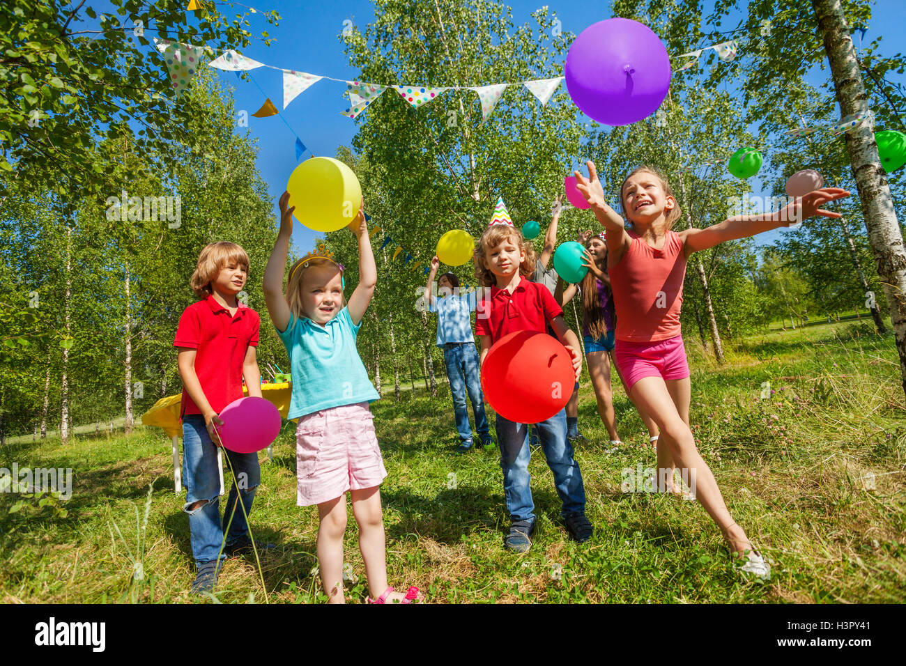 Les enfants jouent drôle de jeu avec des ballons colorés Banque D'Images