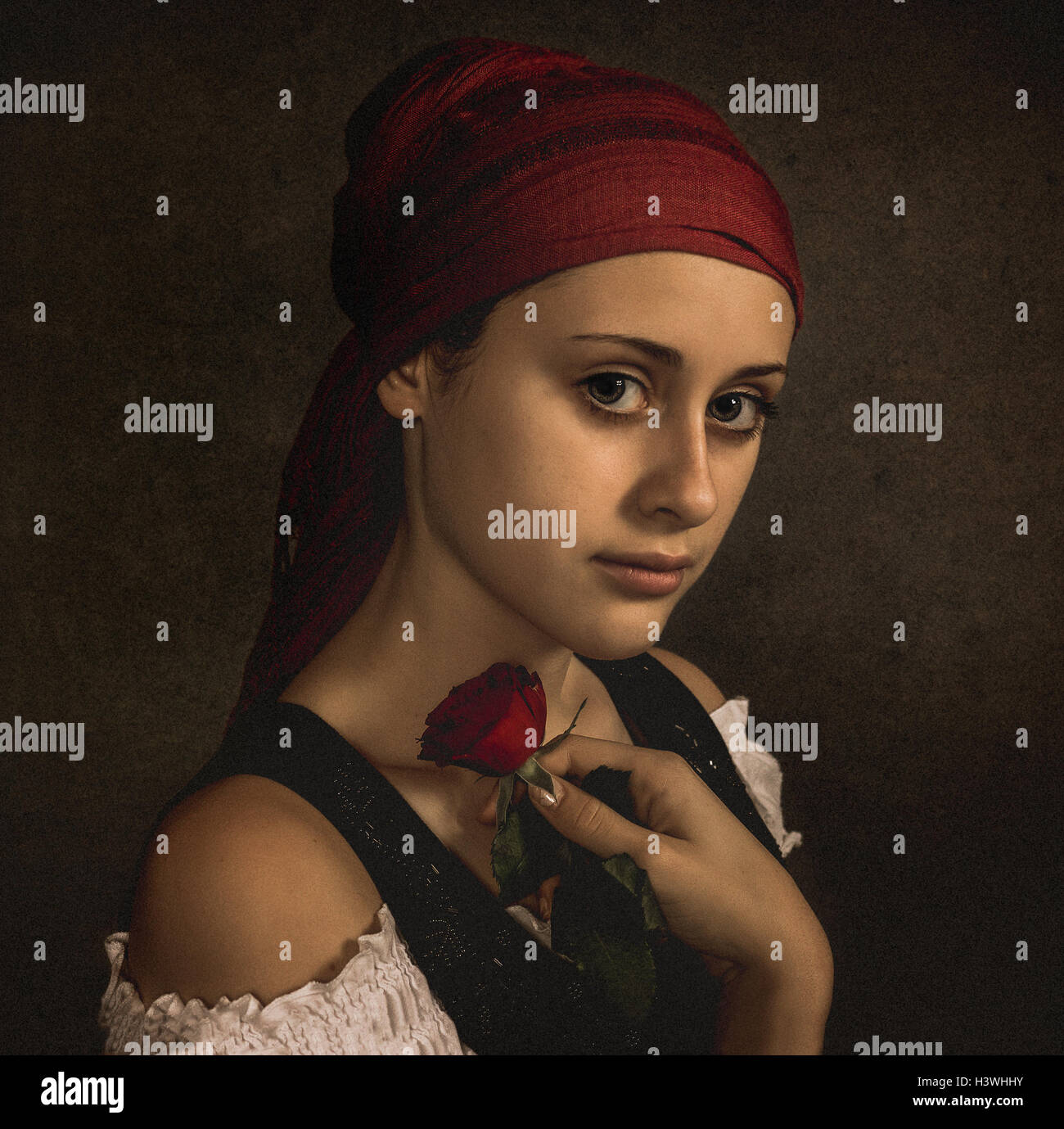 Portrait of a Teenage girl holding une rose rouge Banque D'Images