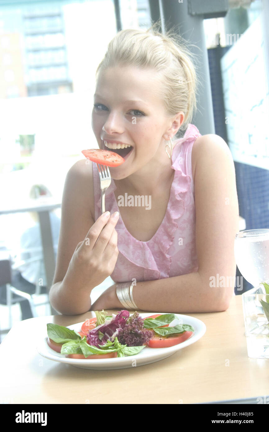 Femme, jeune, heureux, salade, tomate, manger, portrait, portrait de femmes, de 20 à 30 ans, 21 ans, blonde, vêtements, haut, estival, à l'intérieur, à la maison, plaque, plaque de salade, la nutrition, la saine, intermeal, de l'alimentation, l'alimentation, la santé consciente, de vitamines, riche en vitamines, v Banque D'Images