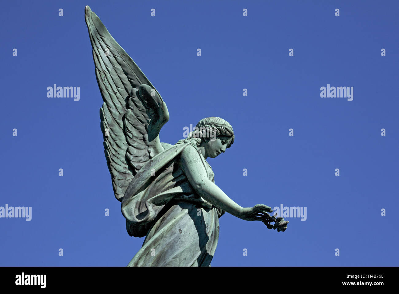 Angel tombe avec rose dans la main avant sur le ciel bleu, cimetière Ohlsdorfer Banque D'Images