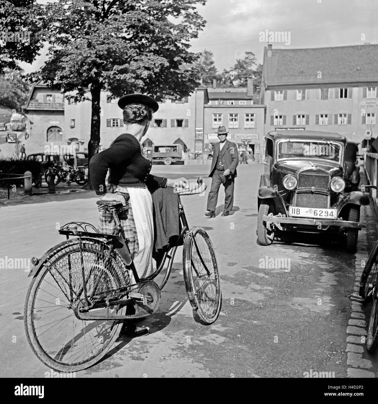 Passanten Kelheim, unterwegs zu Fuß, mit dem Auto oder dem Fahrrad, Deutschland 1930 er Jahre. Passants à Miesbach, sur leur chemin à pied, en voiture ou en vélo, l'Allemagne des années 1930. Banque D'Images