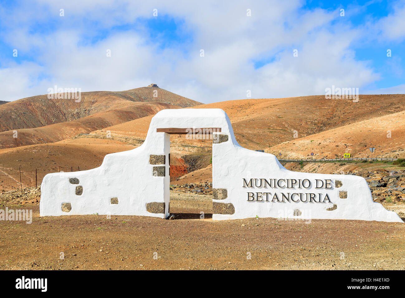 Panneau municipal typique (arche blanche porte) près de Betancuria village avec désert paysage de montagne dans l'arrière-plan, Fuerteventura, Îles Canaries, Espagne Banque D'Images